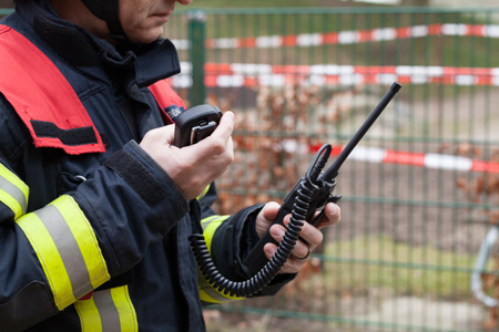midsection-firefighter-holding-walkie-talkie-1.jpg